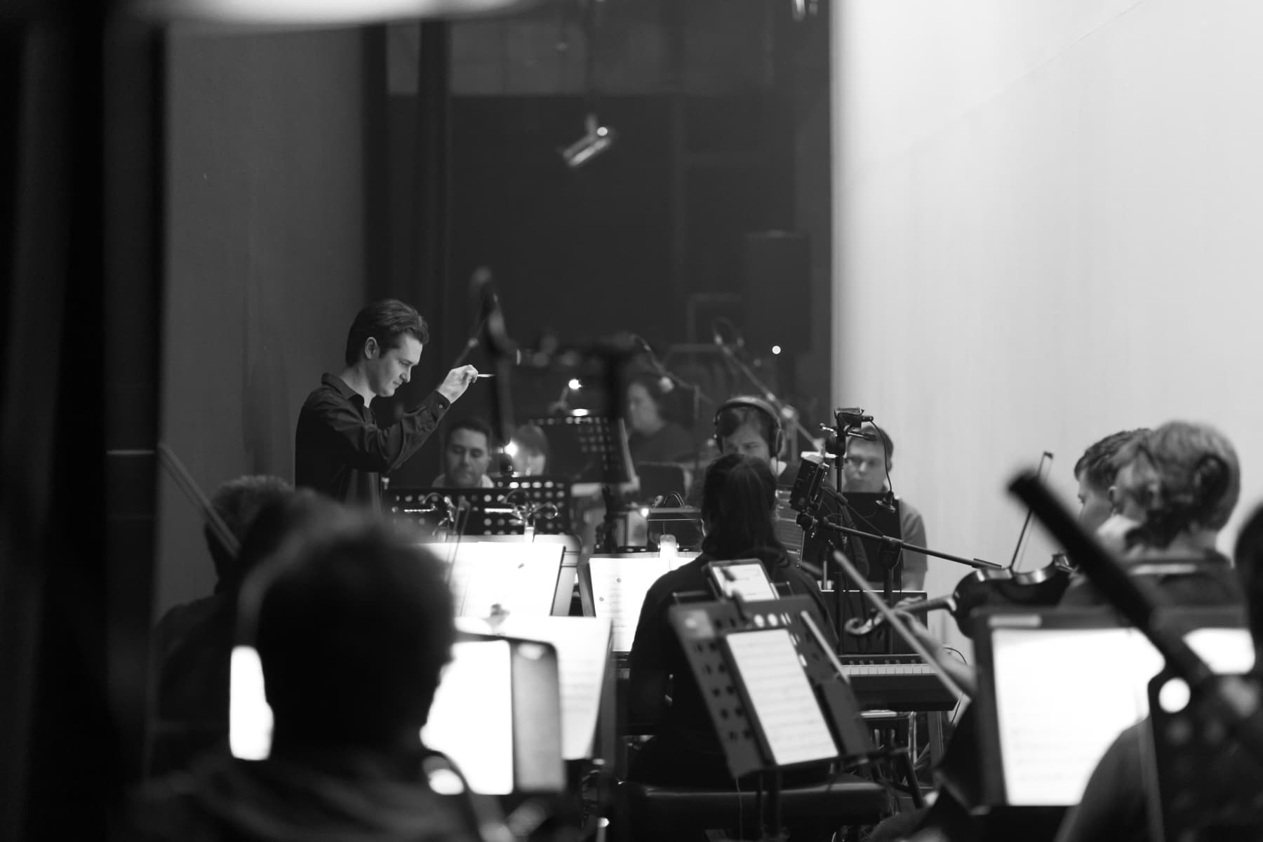 Matthew Rumley conducting the orchestra for The Hunchback of Notre Dame