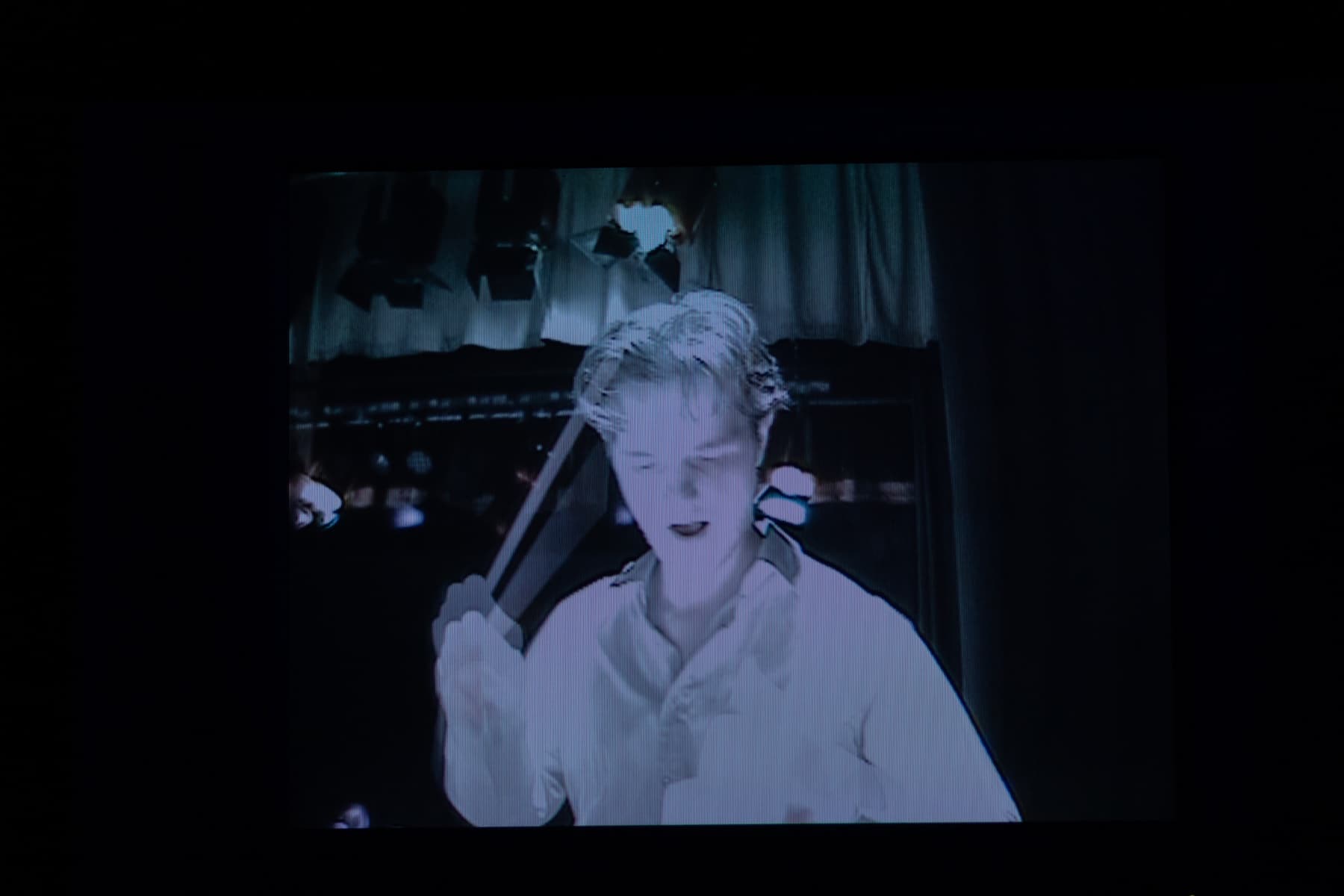 Matthew Rumley conducting Merrily We Roll Along, seen on the orchestra monitor